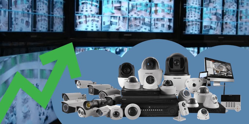 A video surveillance room filled with video security system cameras and equipment and an arrow showing an upward trend