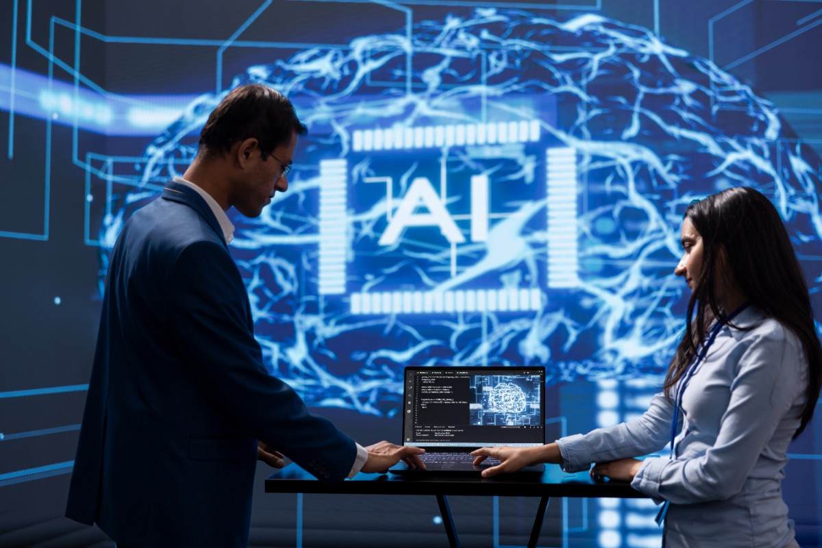 a man and women working displaying AI over screen