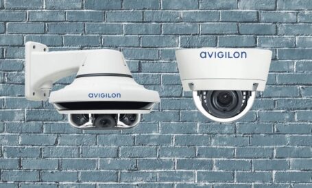 Avigilon indoor and outdoor dome cameras against a brick backdrop